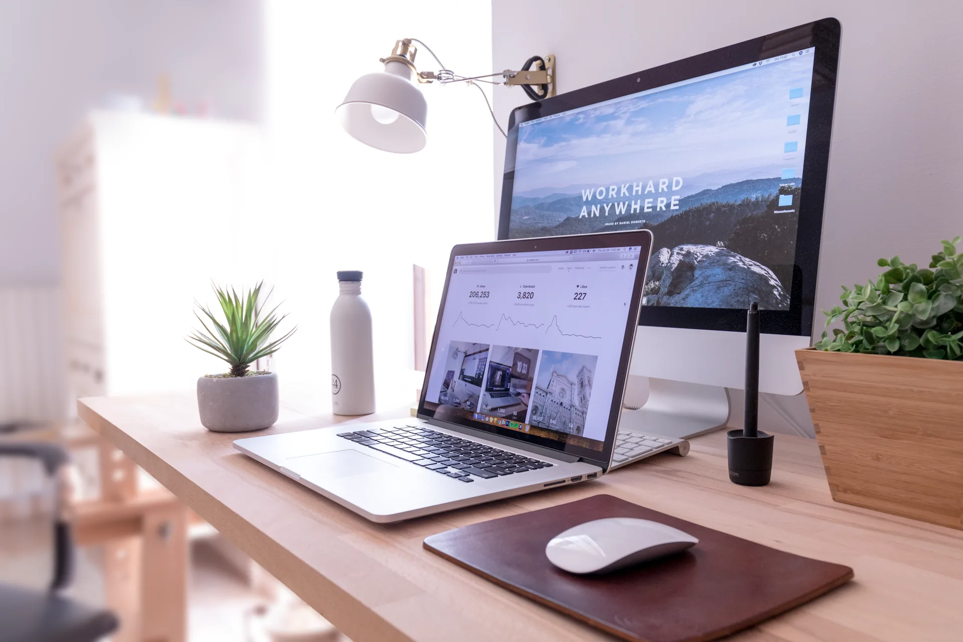 Professional workspace with multiple monitors showing enterprise website design